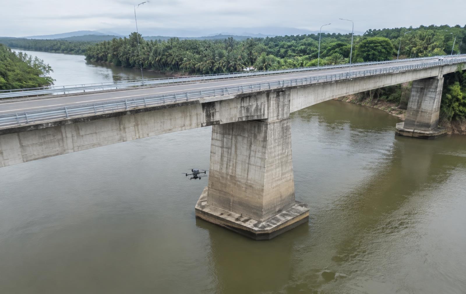 Inspection drone beside a river bridge pier